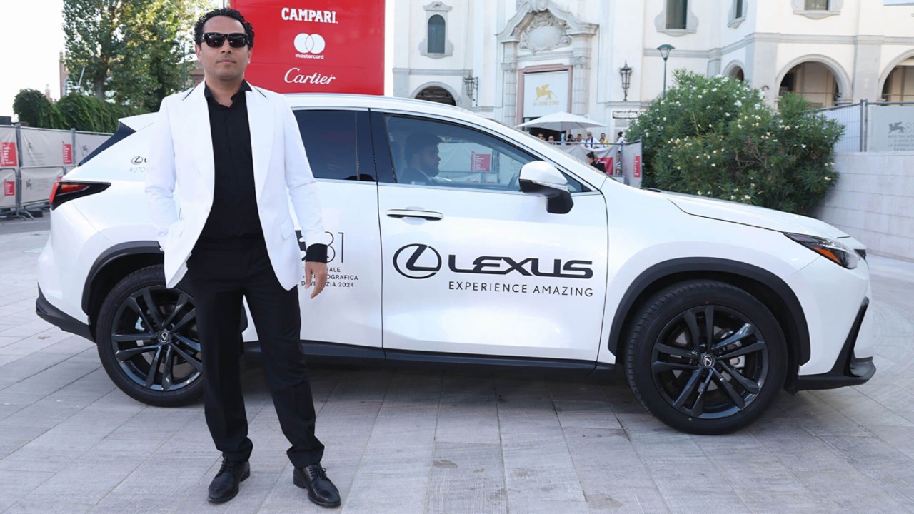 A person stood by a Lexus at the 81st Venice film festival