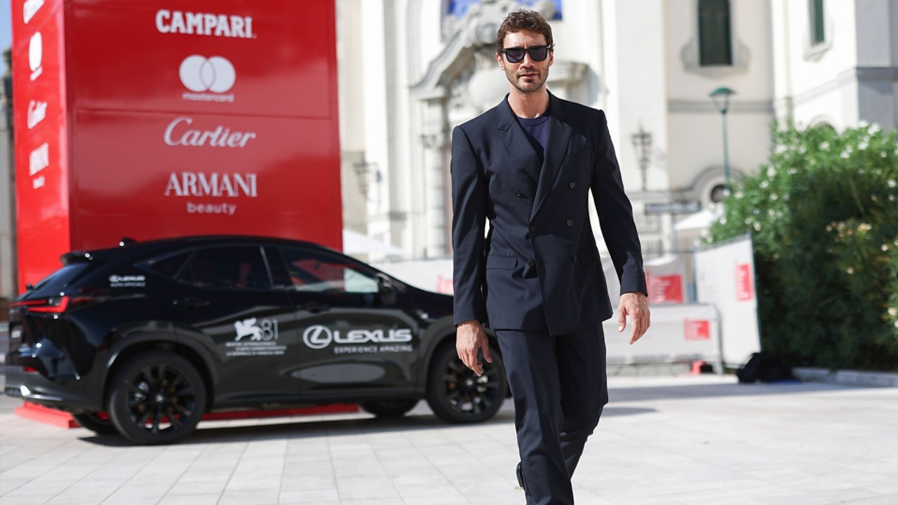 Stefano De Martino walking away from a parked Lexus at the 81st Venice film festival